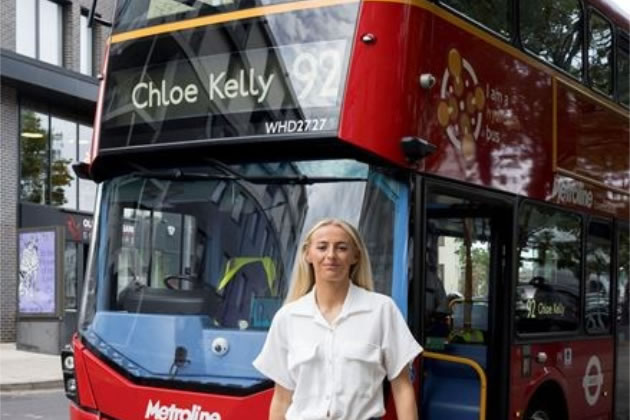 Chloe Kelly in front of her own 92 bus 