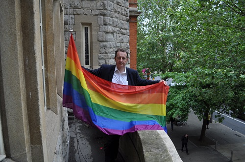 Julian Bell raises rainbow flag