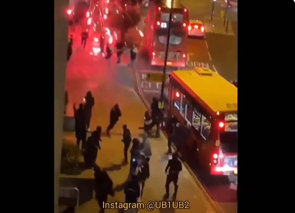 Firework explodes above police officers on The Broadway, Greenford 