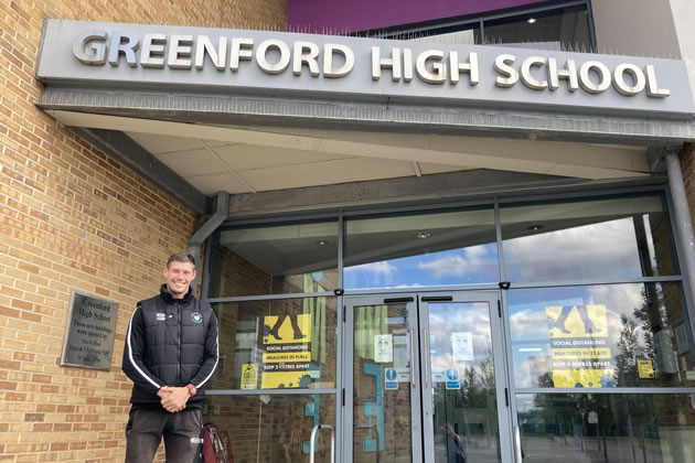 Mark Harvey at the entrance to Greenford High School 