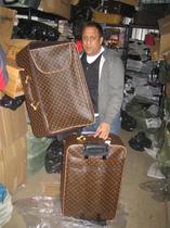 Ealing Council trading standards officer with counterfeit Louis Vuitton luggage