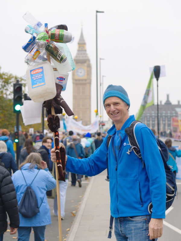 Ben Morris holding aloft a stick covered with the sort of detritus dragged out of the River Brent 