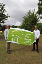 Manager of Brent Lodge Park Animal Centre, Jim Gregory, and cabinet member for environment and transport, Councillor Bassam Mahfouz holding the Green Flag in Brent Lodge Park.